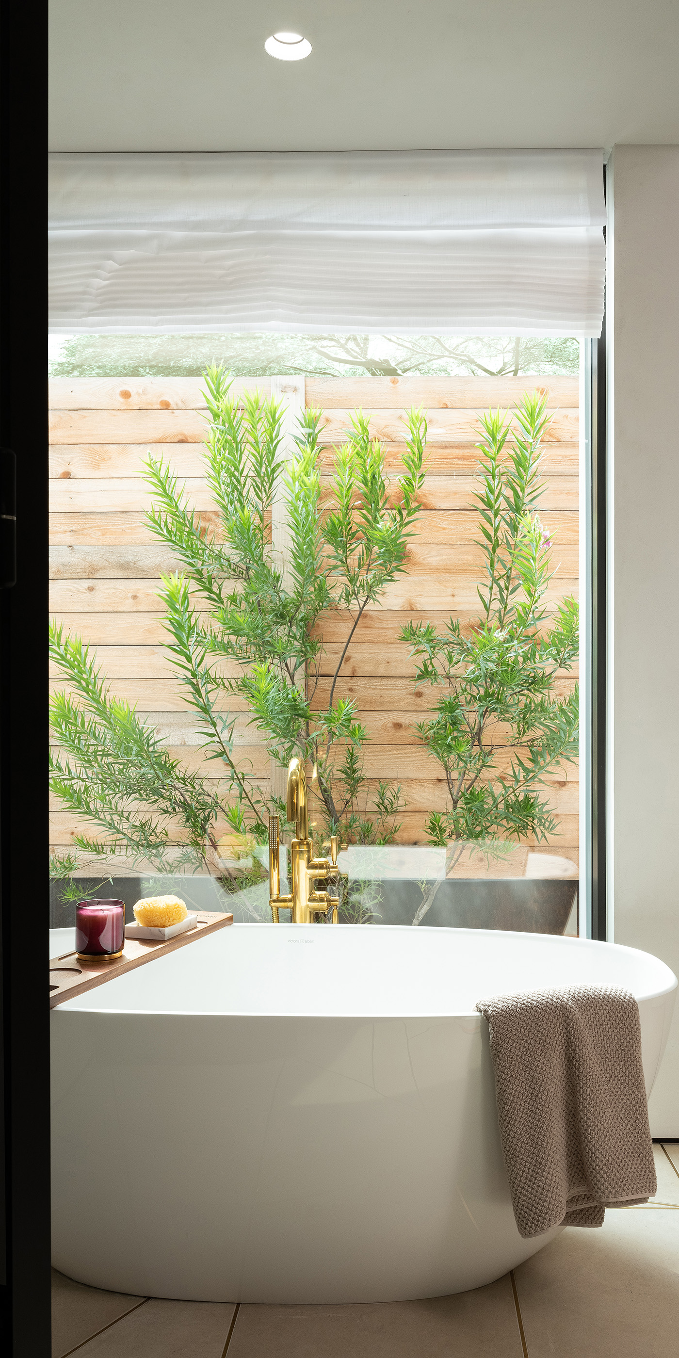 An Austin residential bathroom with Lutron Ketra lights, Roman shades, Sivoia and HomeWorks.
