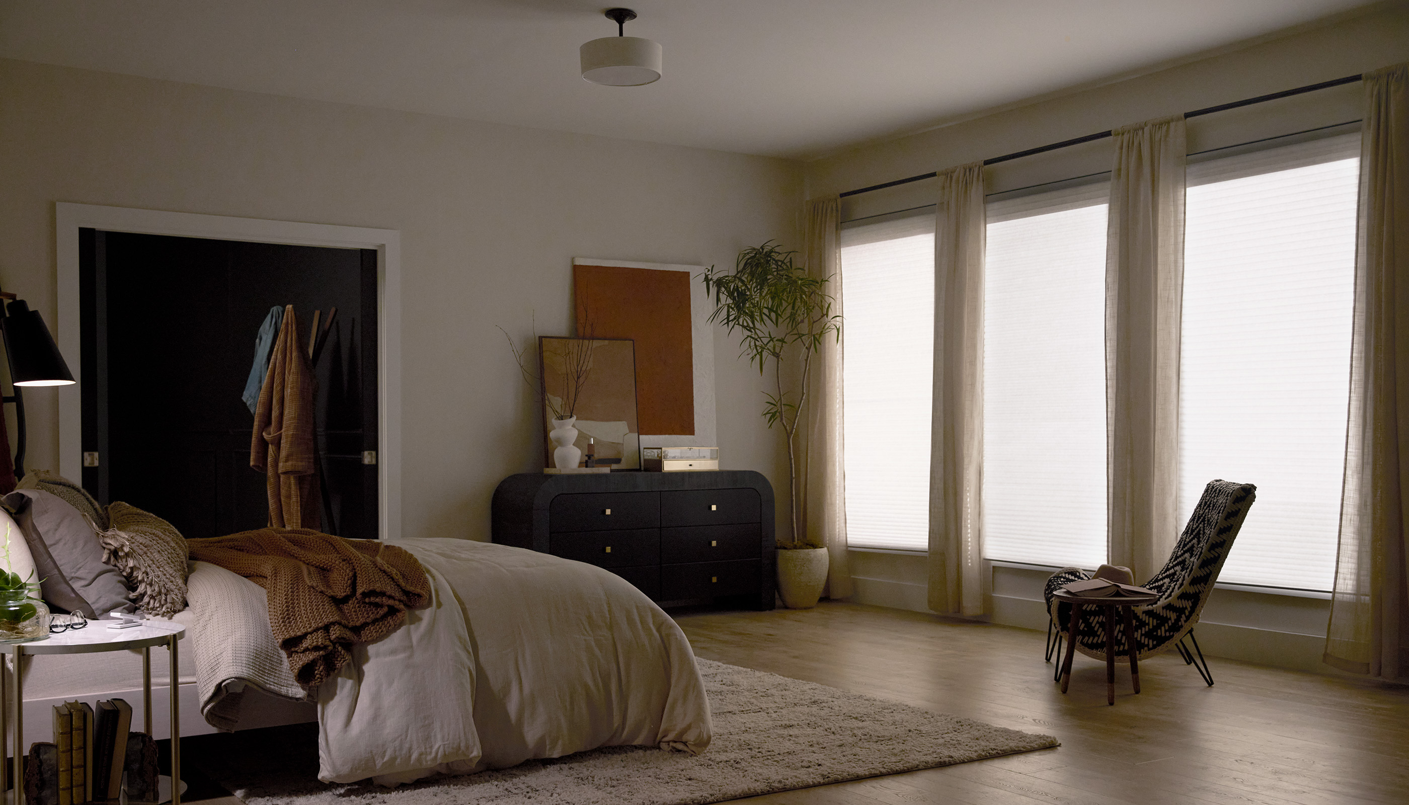 A Northeast private residence bedroom with Lutron Serena & Honeycomb Shades