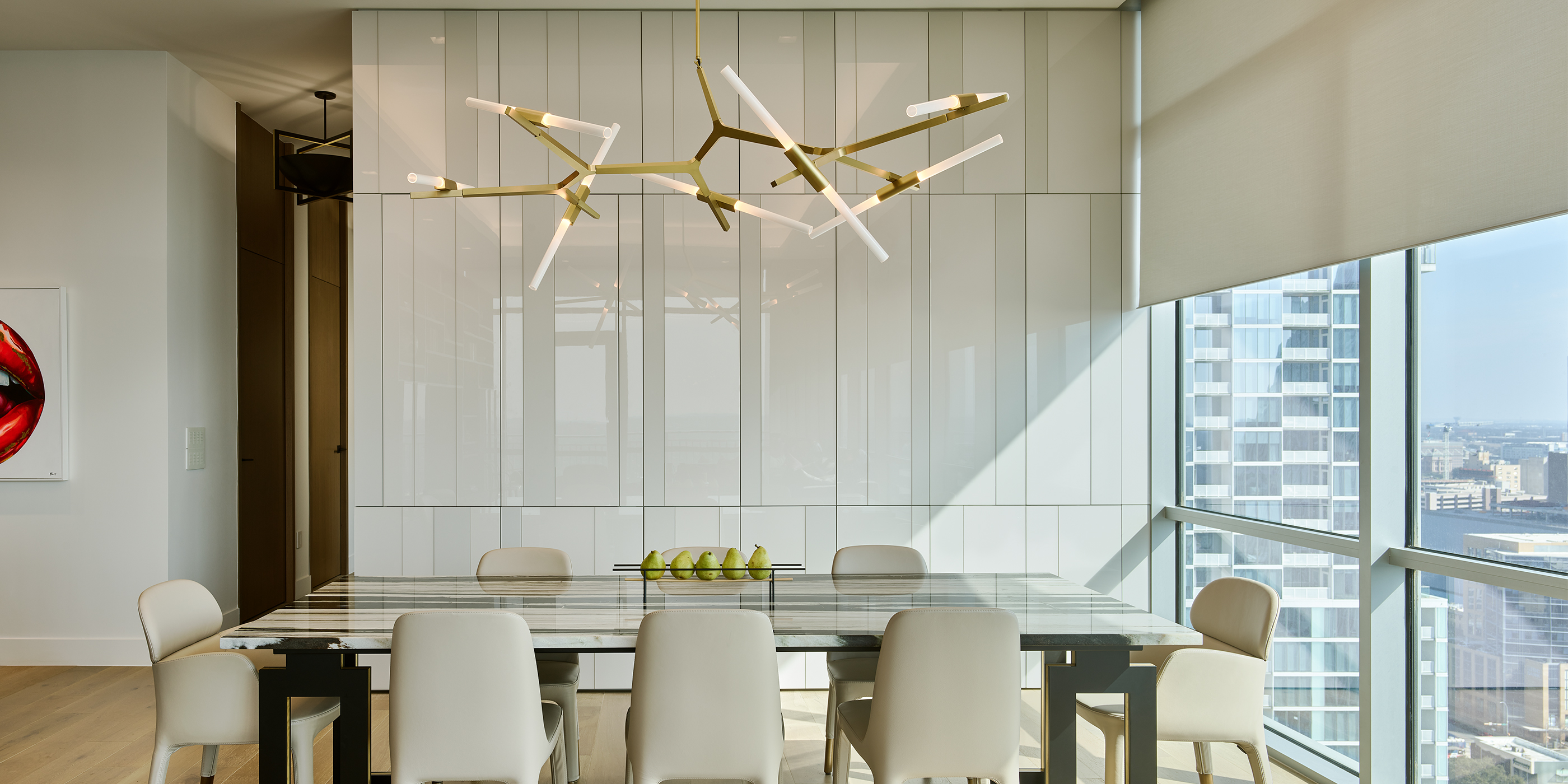 An Austin residential dining room with Lutron downlights, roller shades, and Palladiom.