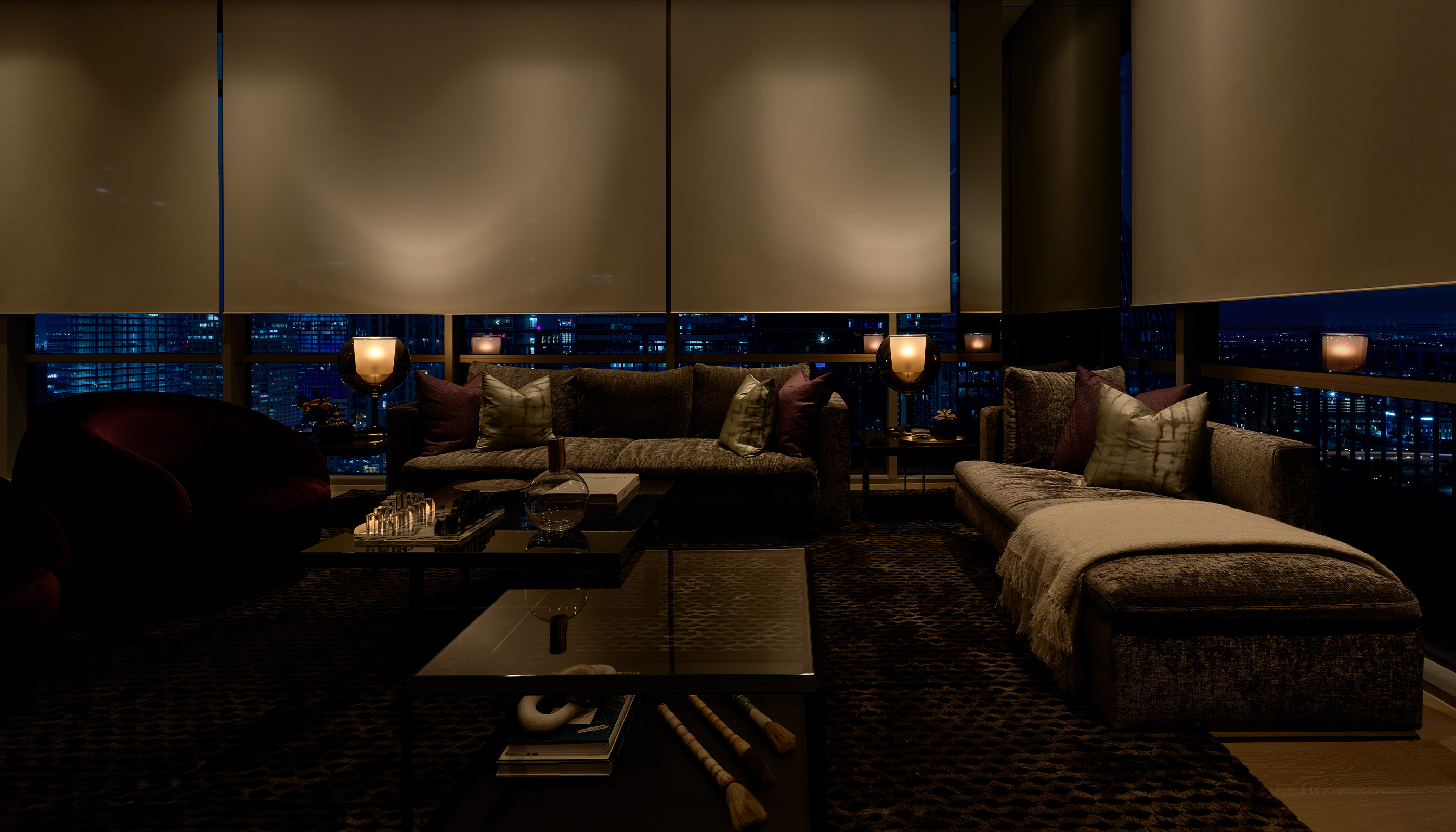 An Austin residential living room with Lutron Ketra lights, Palladiom roller shades, and HomeWorks.