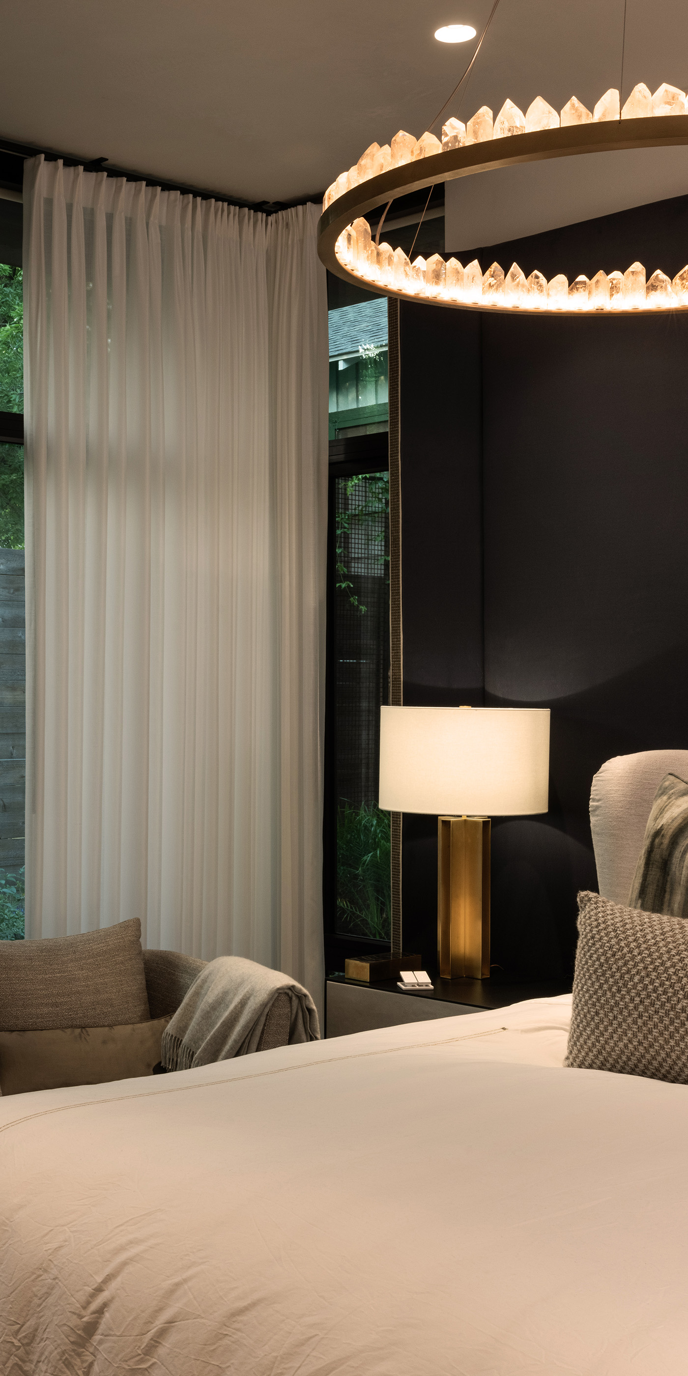 An Austin residential bedroom with Lutron Ketra lights, Roller shades, Sivoia and HomeWorks.