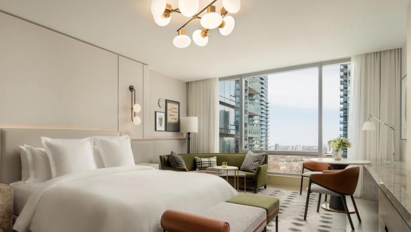 myRoom XC connected hospitality solution in modern hotel guest room with city skyline views