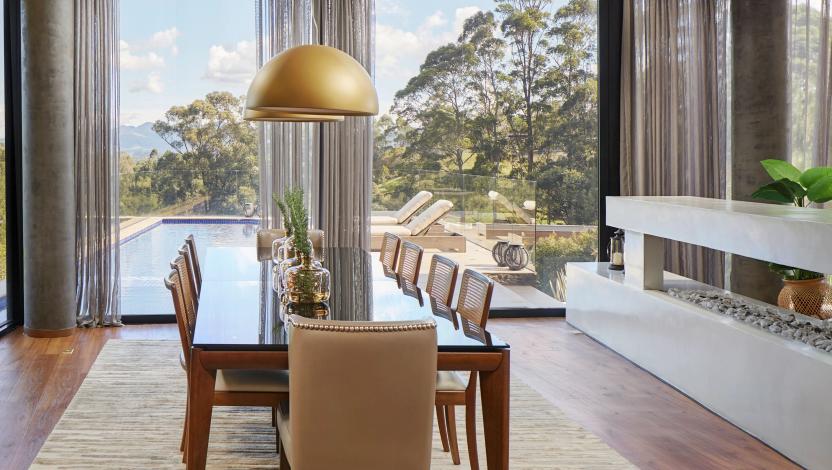HomeWorks luxury home integration system in modern dining room with panoramic windows