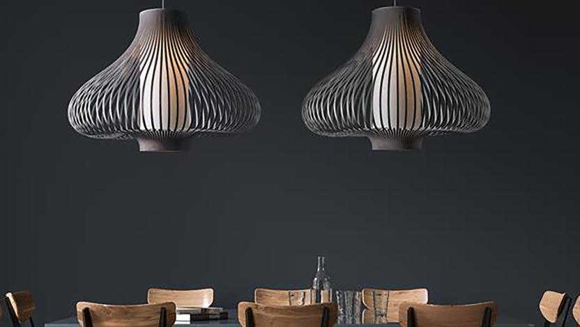 Dining space with sculptural pendants and a dark material palette that emphasizes form, texture, and furnishings.