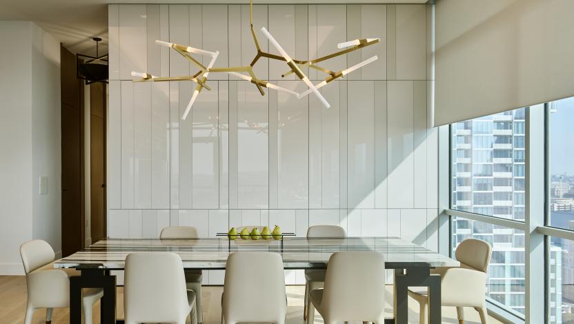An Austin residential dining room with Lutron downlights, roller shades, and Palladiom.