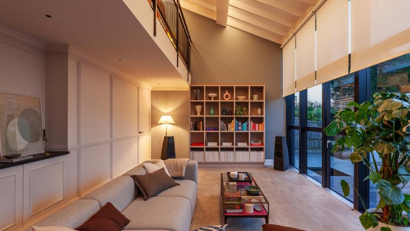 Modern, open-concept living room with relaxed interior lighting.