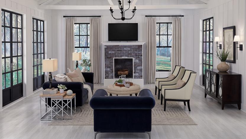 Modern living room with expansive windows and lighting that highlights seating, finishes, and architectural details.