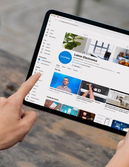 Up-close image of someone watching Lutron videos on a tablet.