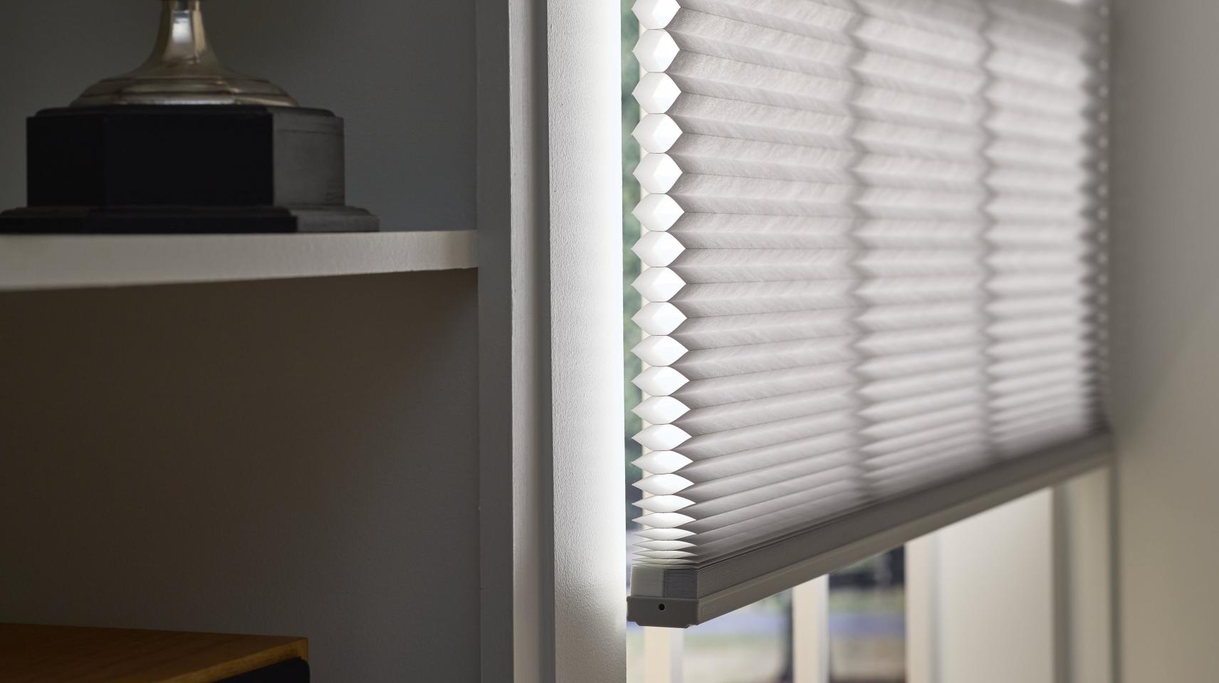 White cellular shades in modern kitchen with smart scheduling for energy efficiency