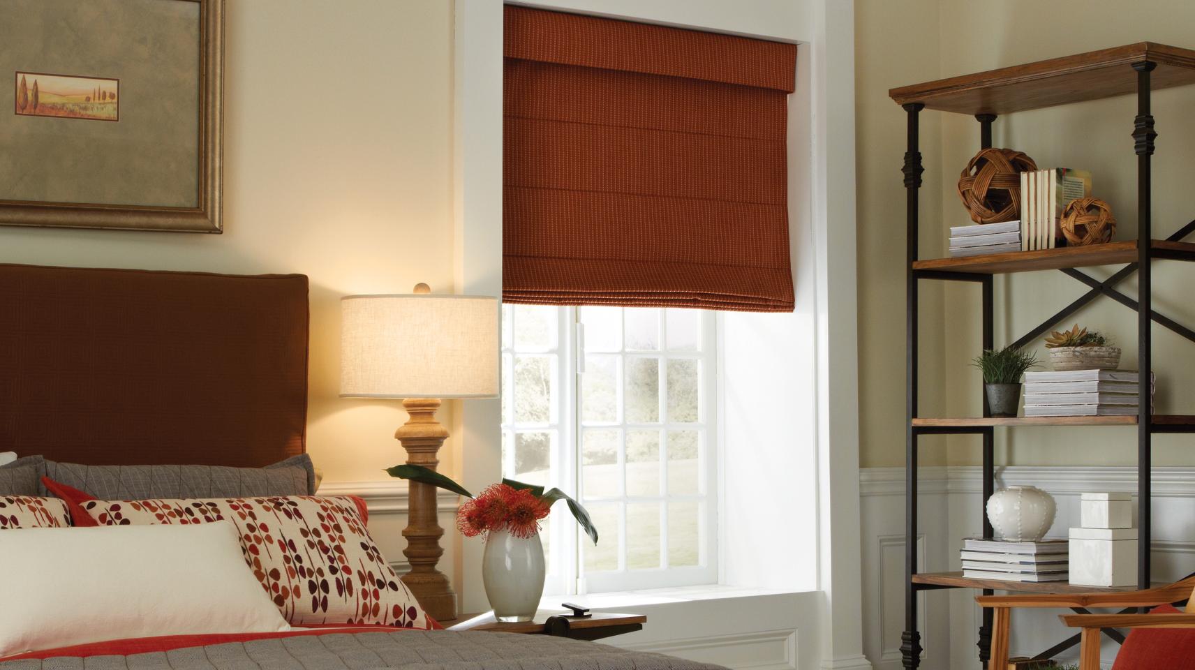 Lutron motorized Roman shades in bedroom with whisper-quiet automation for privacy control