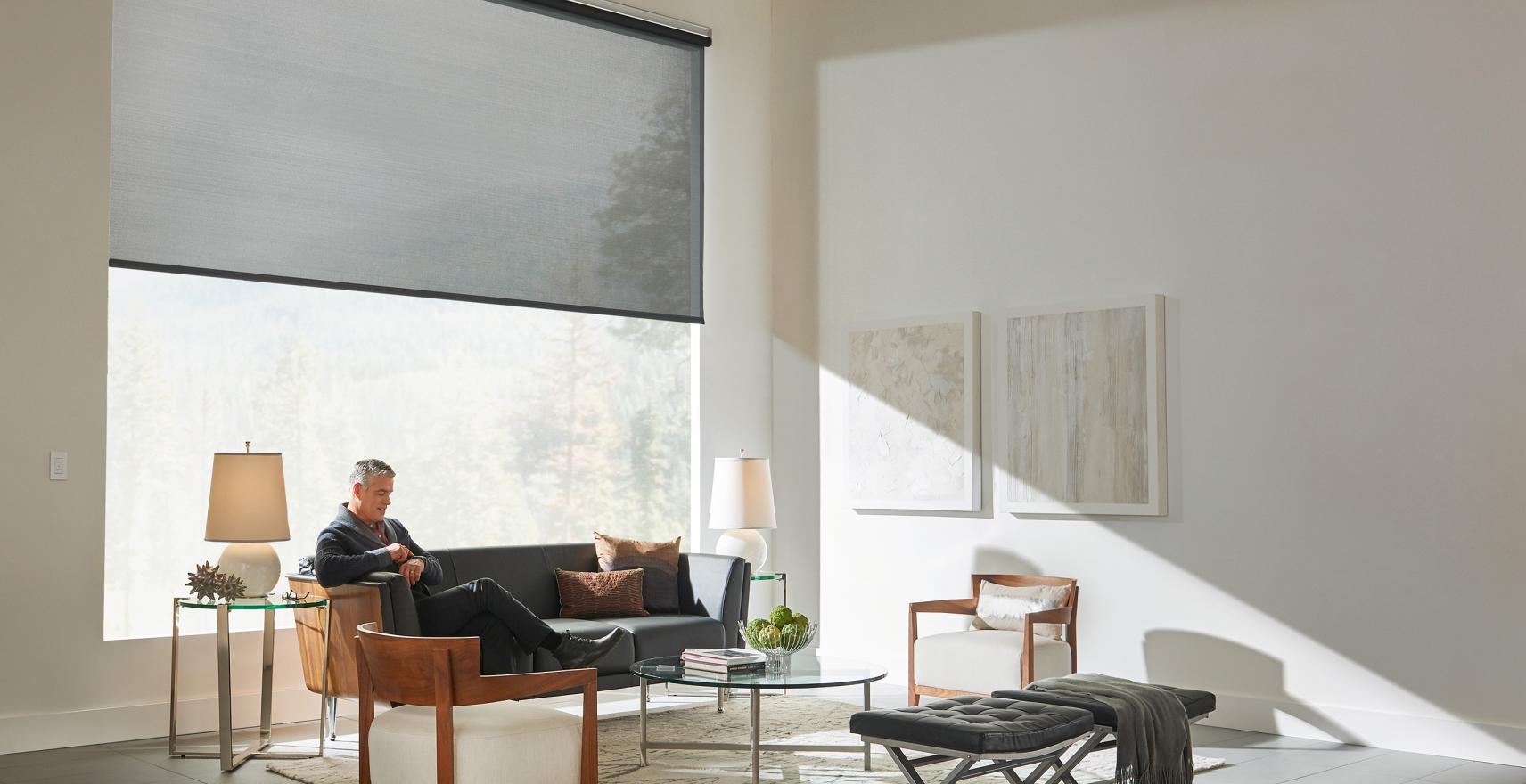 Modern living room with automated roller shades halfway down.