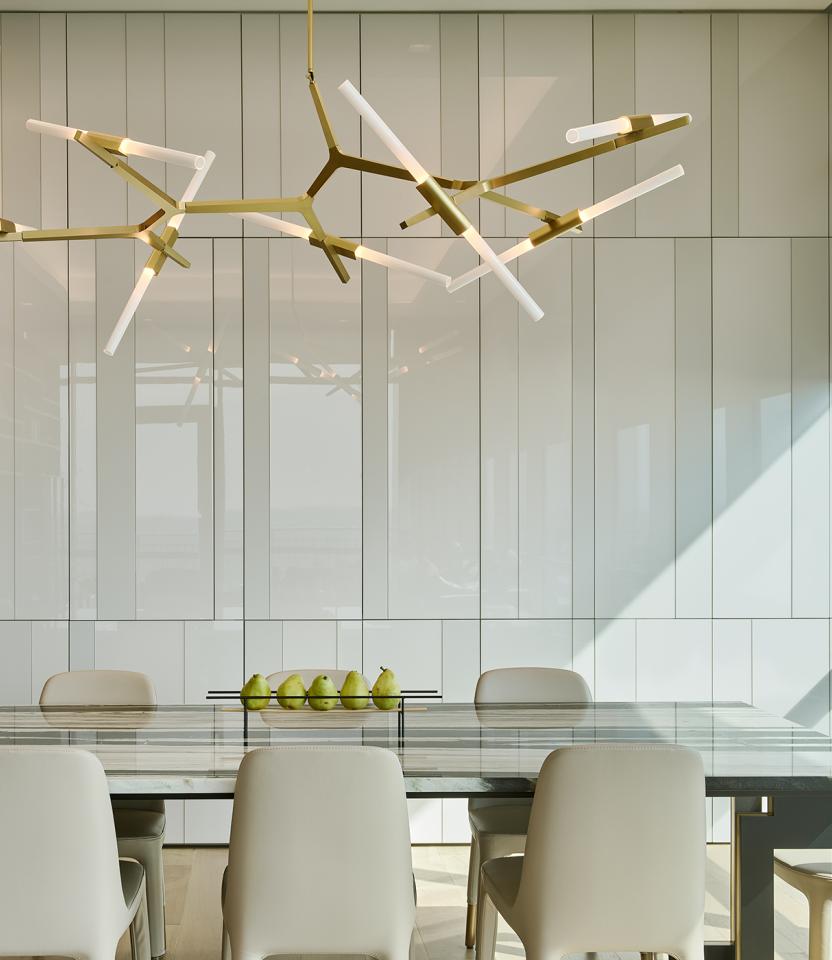 An Austin residential dining room with Lutron downlights, roller shades, and Palladiom.