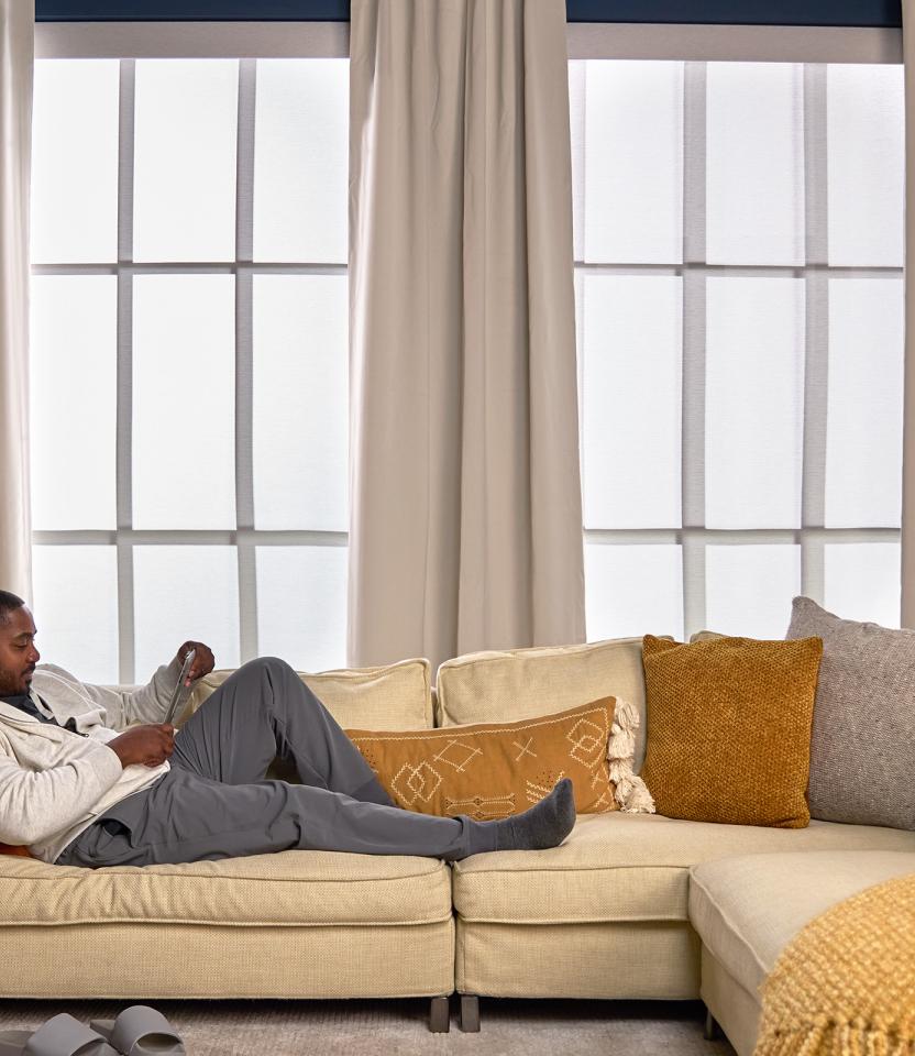 A Northeast private residence living room with Lutron Serena, Roller Shades