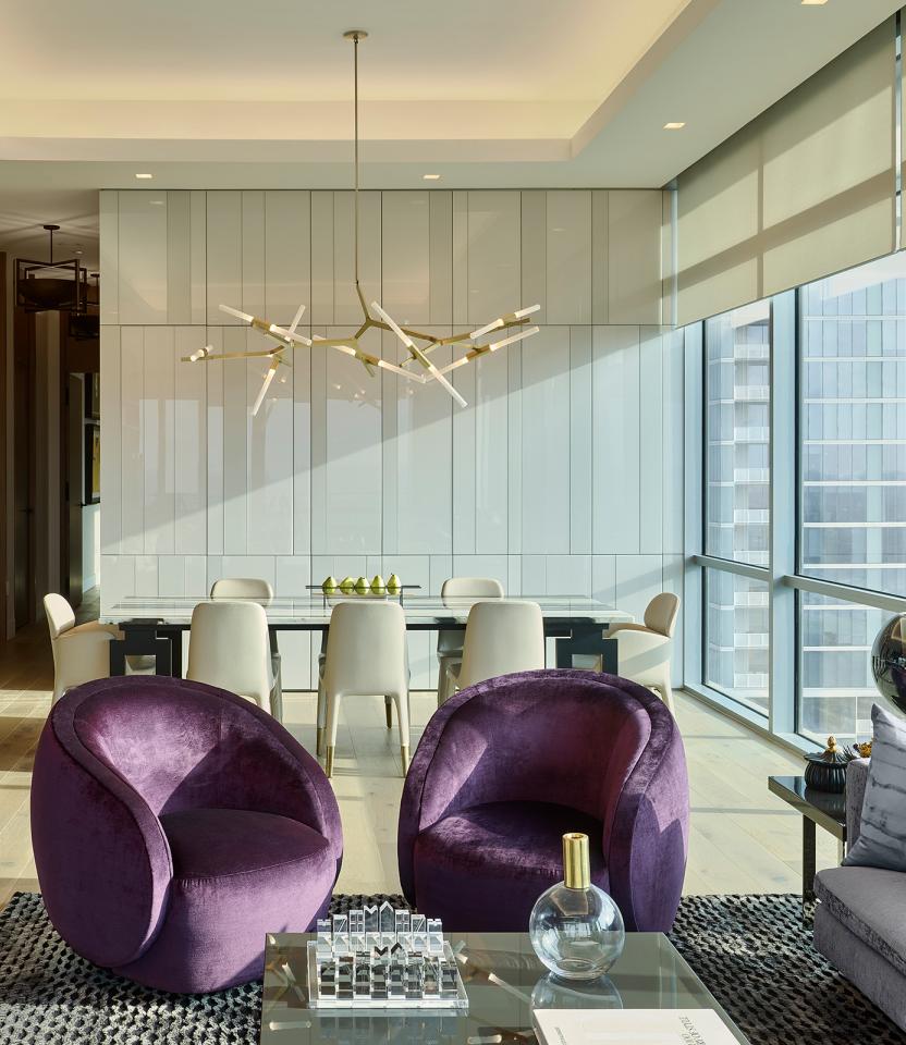 An Austin residential living room with Lutron Ketra lights, Palladiom roller shades, and HomeWorks.