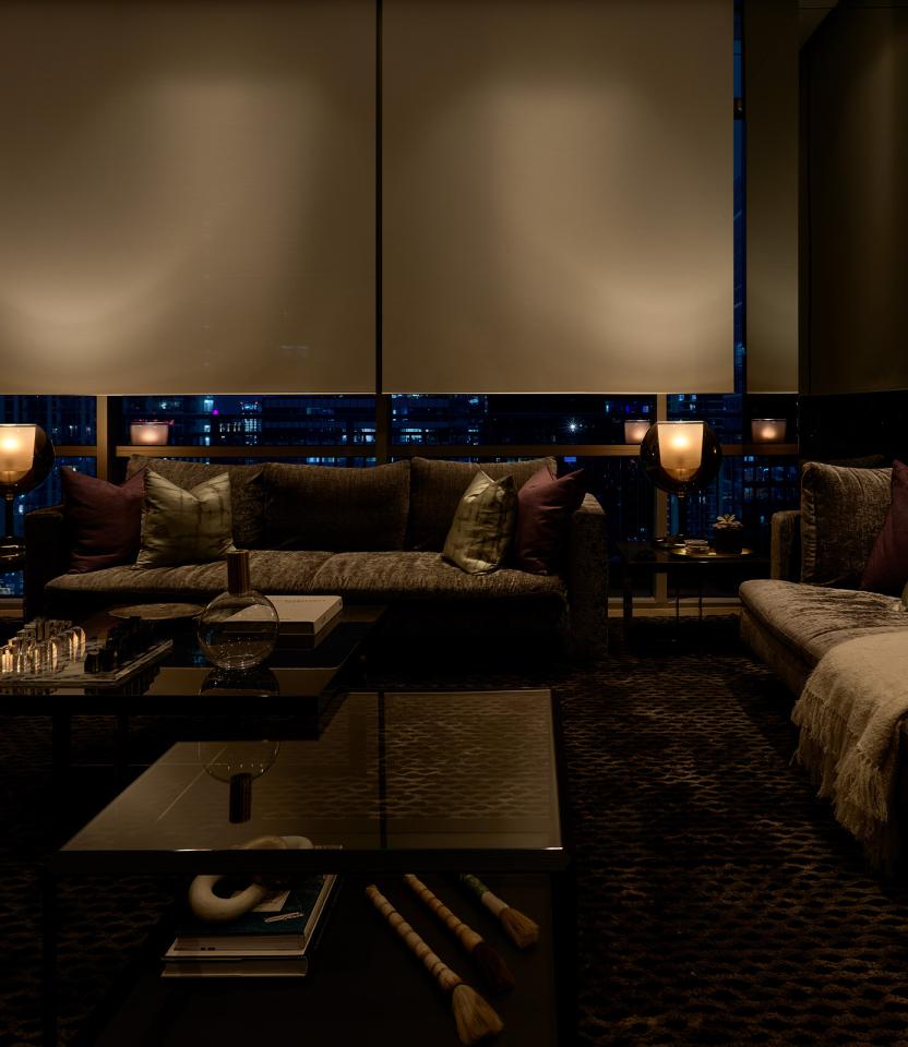 An Austin residential living room with Lutron Ketra lights, Palladiom roller shades, and HomeWorks.