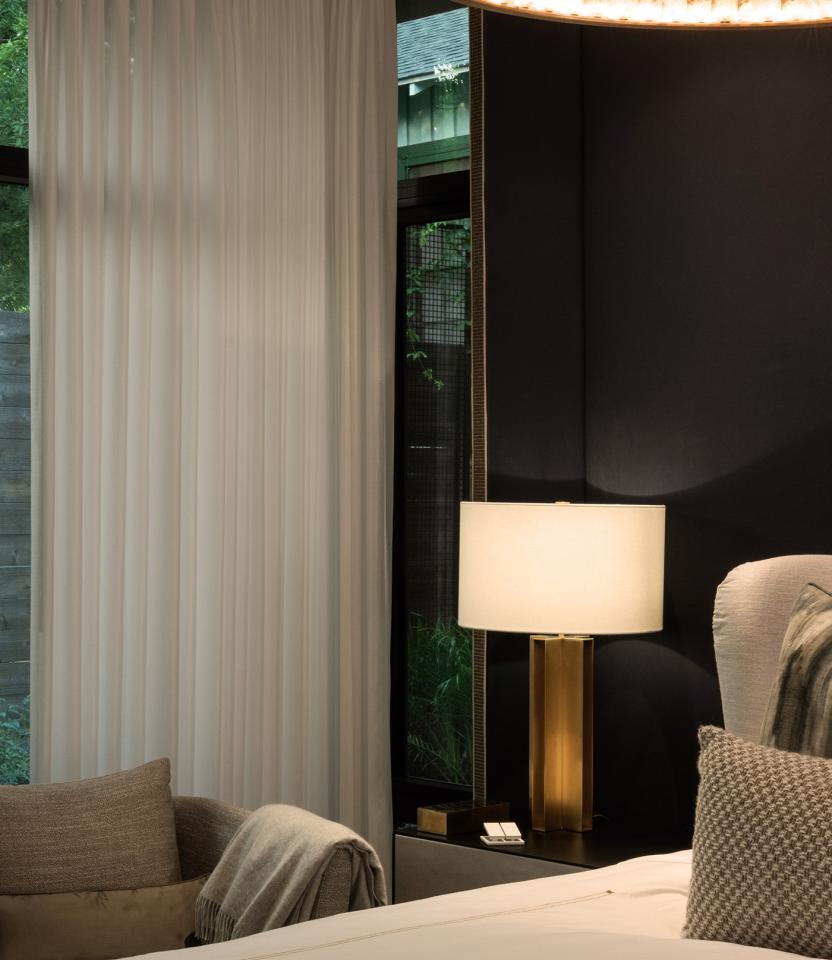 An Austin residential bedroom with Lutron Ketra lights, Roller shades, Sivoia and HomeWorks.
