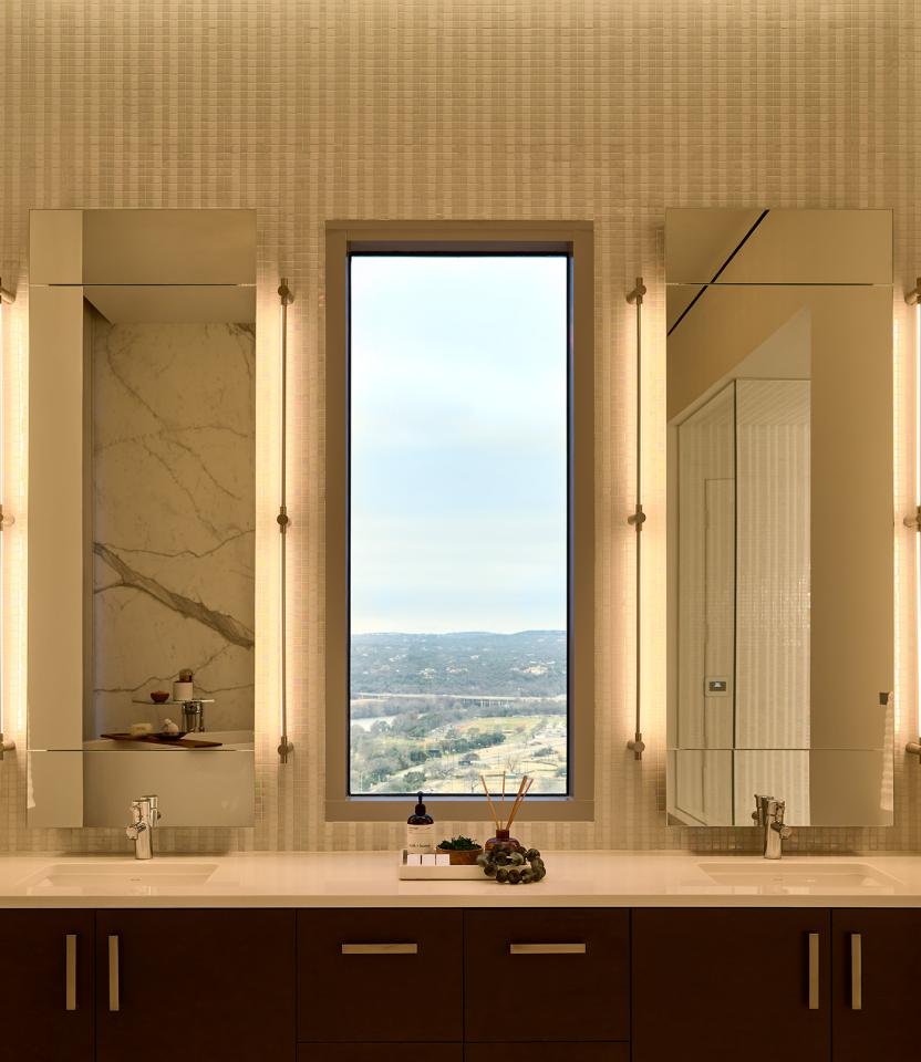 An Austin residential bathroom with Lutron Ketra lights, Palladiom roller shades, and HomeWorks.