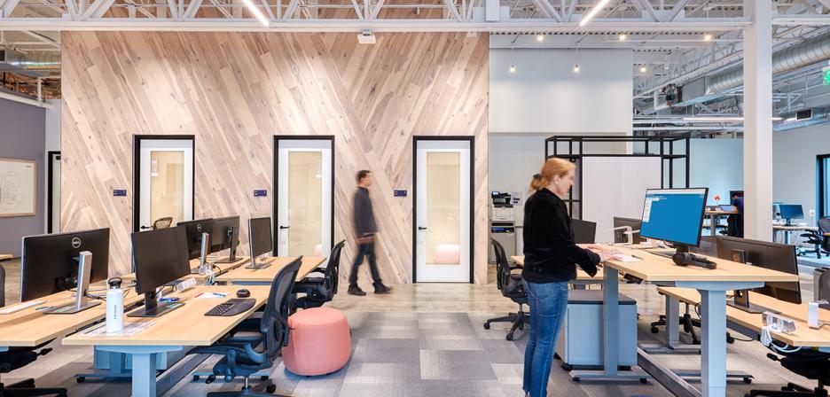 Employees work at an illuminated office