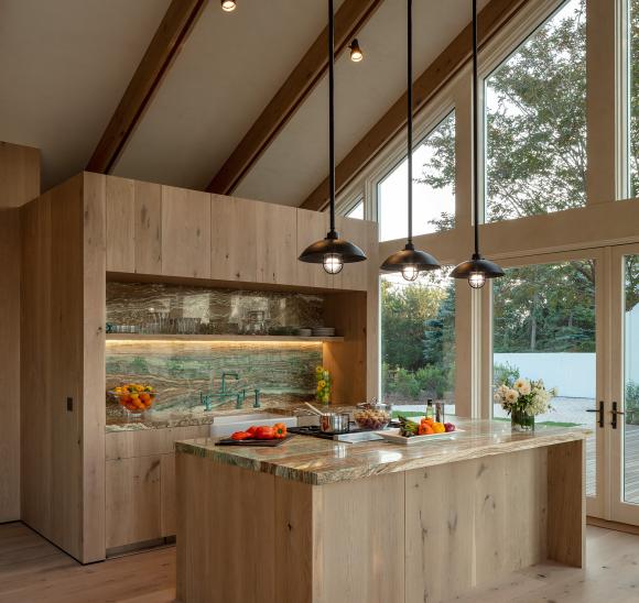Kitchen with natural materials illuminated by full-spectrum light that transitions from task to ambient lighting.