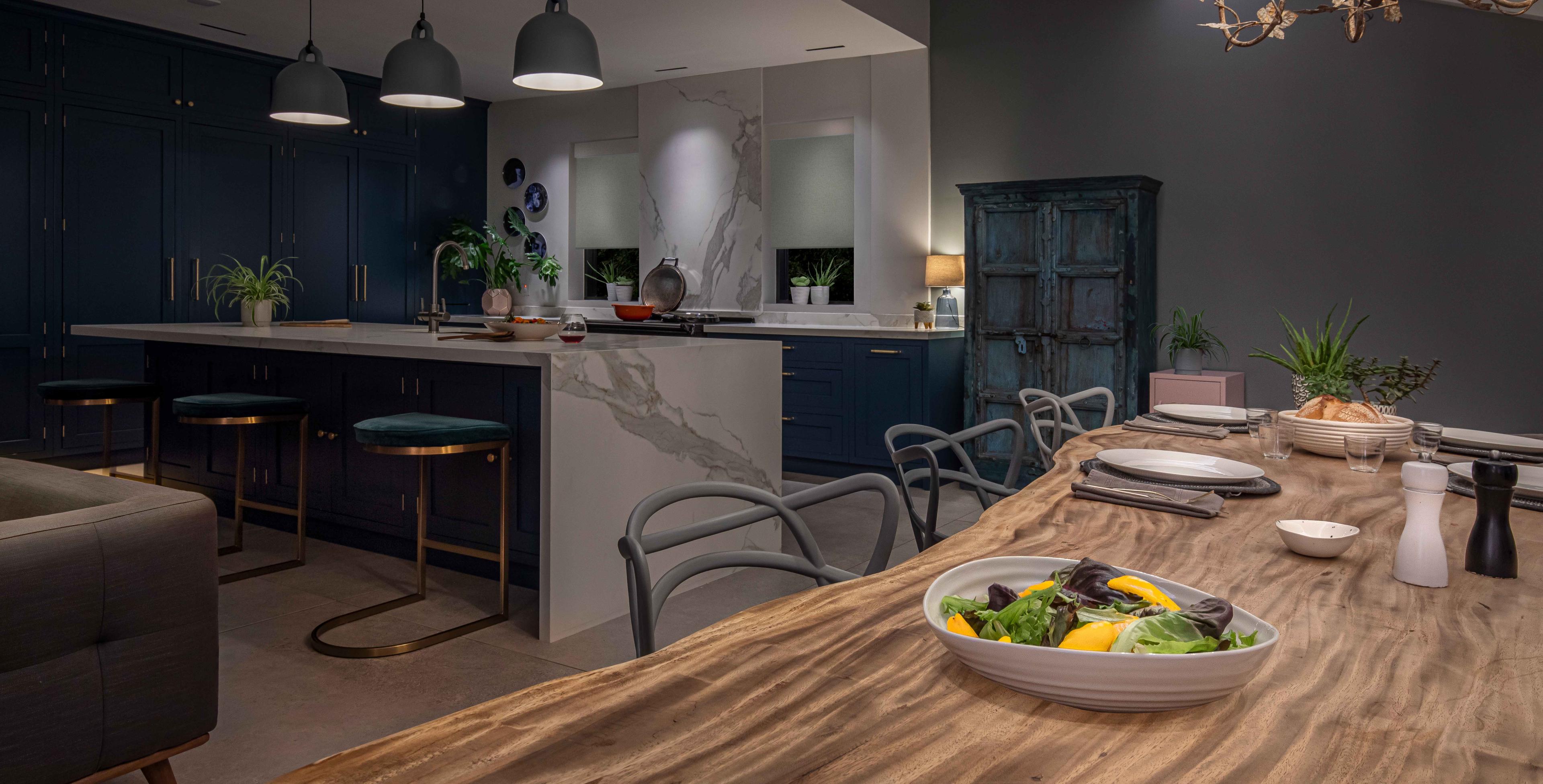 Low, intimate lighting in a kitchen and dining room setting.