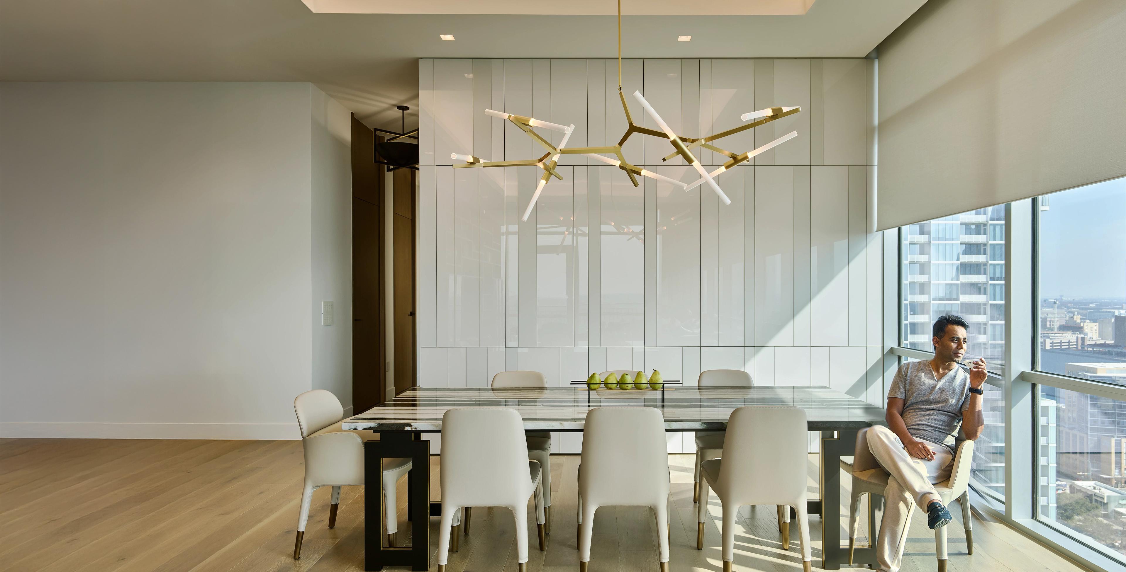 Modern dining room automated roller shades floor-to-ceiling windows high-rise view