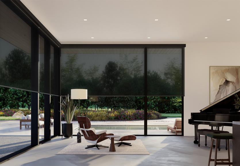 Whisper-quiet shades move together across the living room’s floor-to-ceiling windows to filter sunlight and increase privacy.