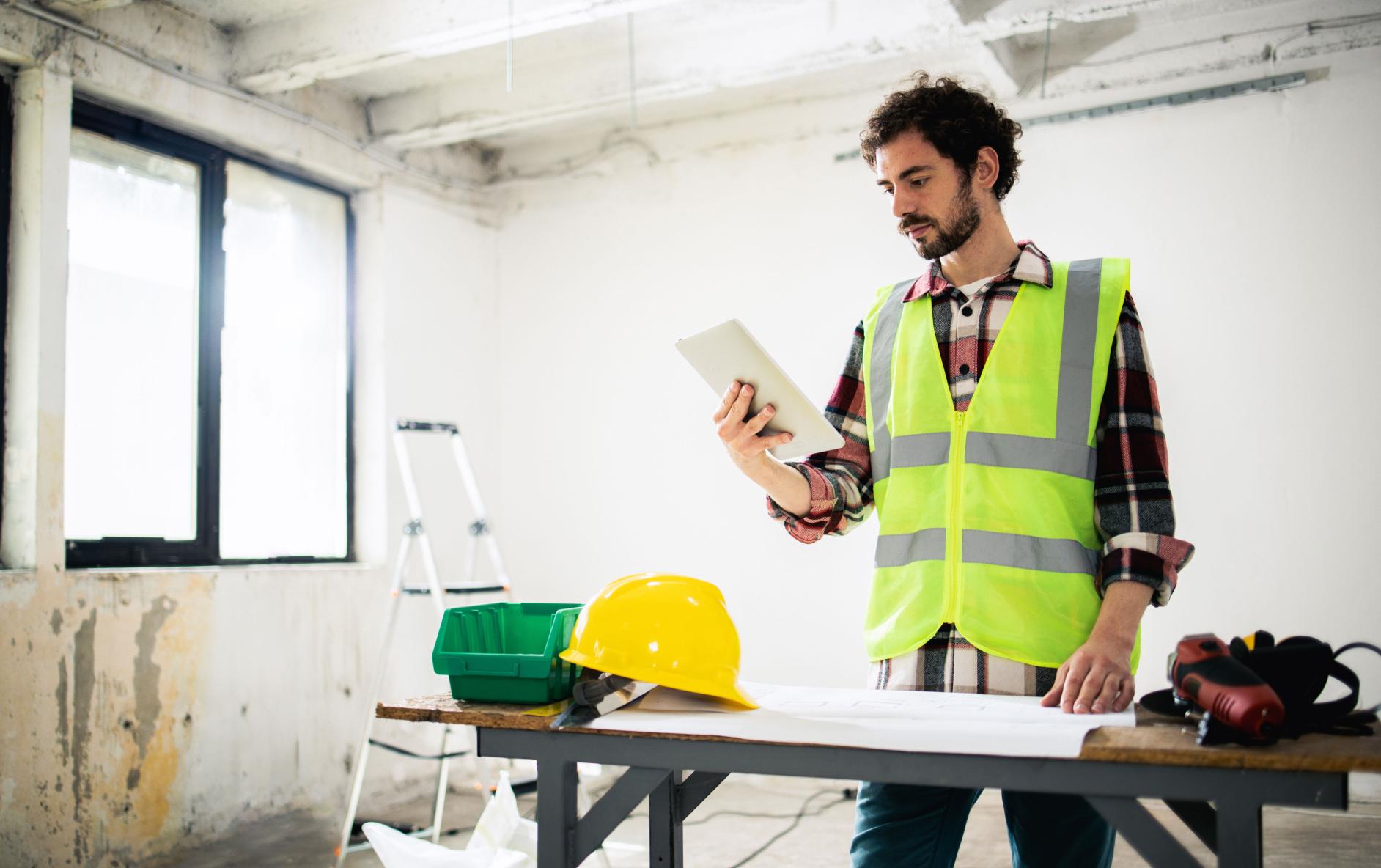 A contractor is using a tablet to get help with a job.